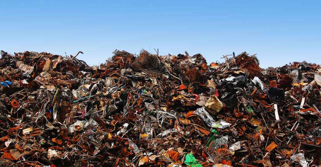 Landfill in front of blue sky.