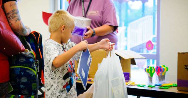 Kid gets school supplies.