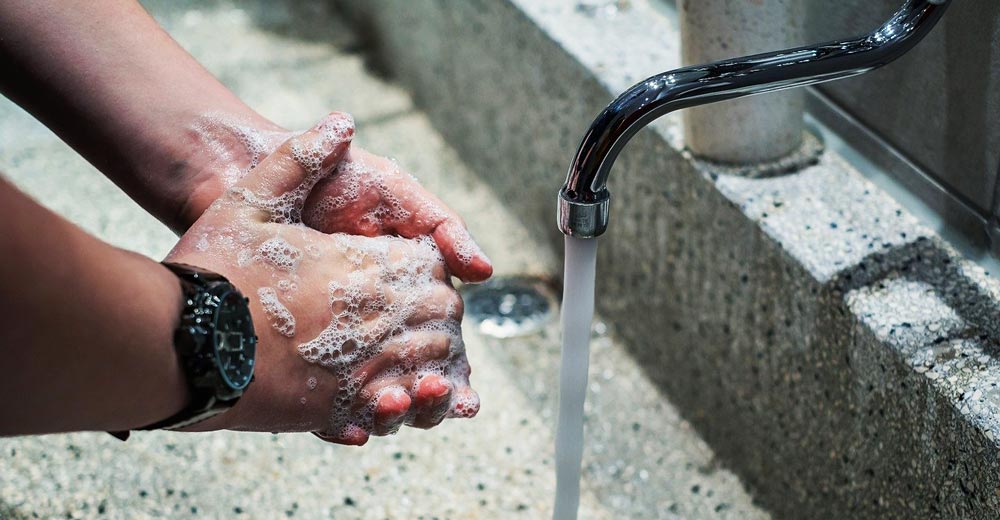 Washing hands with soap and water.