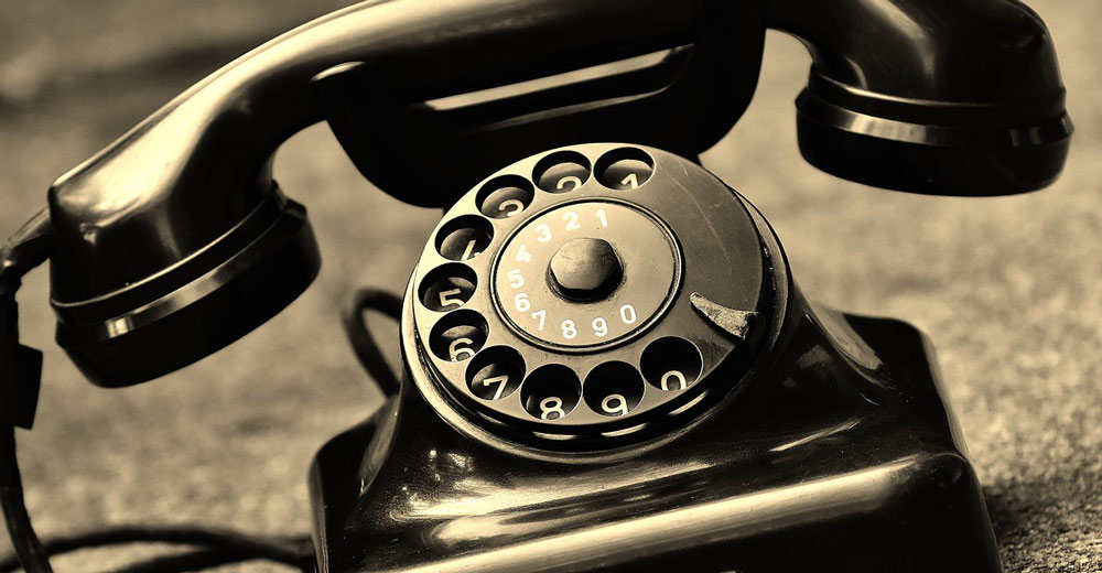 Old telephone on surface.