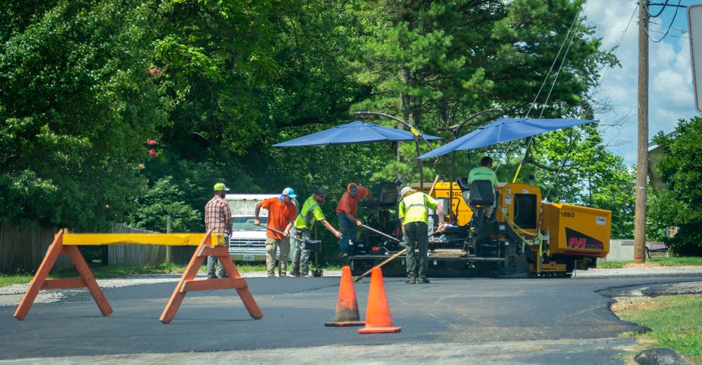 Road workers paving road, resurfacing