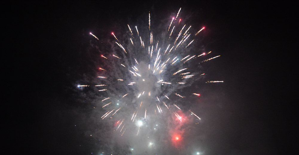 Fireworks over dark, smokey sky