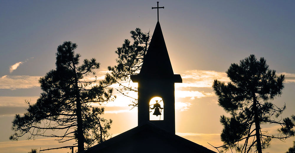 church at sunset with its bell tower