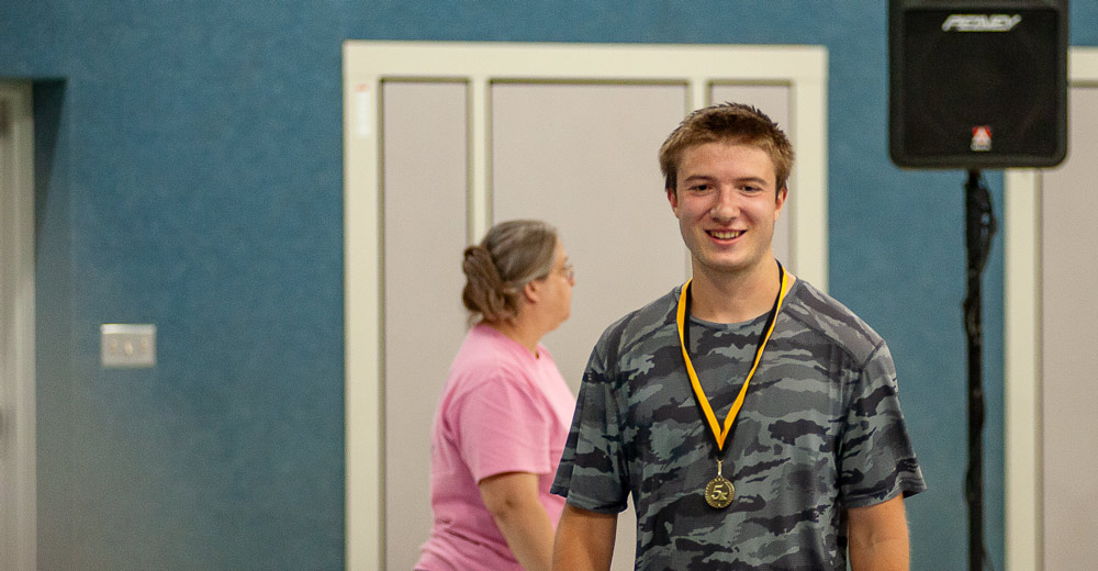 David Thomas receives Gold medal for first place in the Run the Town for the Gold 5k run in Alton, Mo.