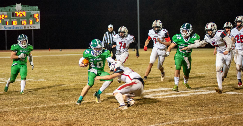 THAYER, MO – NOVEMBER 5: Thayer Bobcats quarterback Landry Pitts (10) tries to dodge a Pirate while going for the endzone during the high school football game between the Thayer Bobcats and the Ash Grove Pirates on November 5, 2021, at the Thayer High School football field in Thayer, MO. (Photo by Curtis Thomas/AltonMo.com)