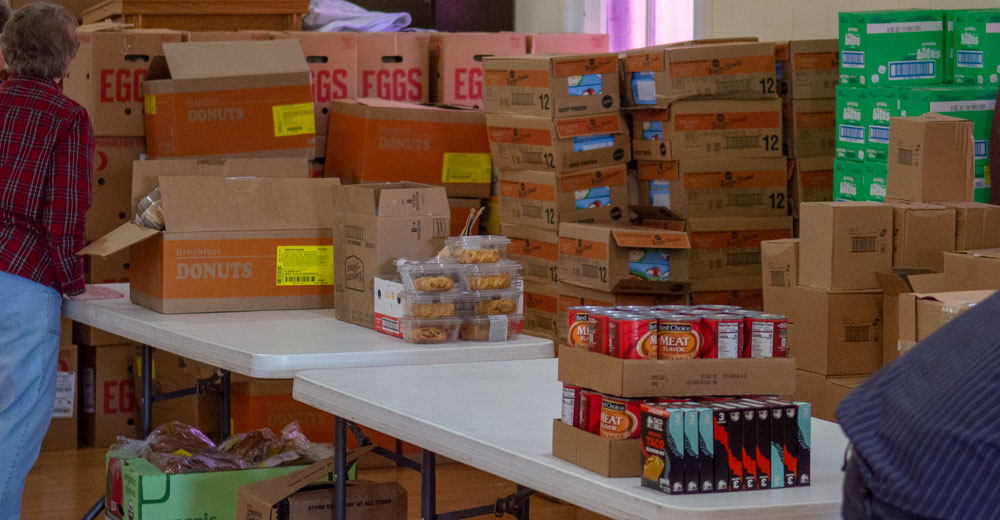 Boxes of cans, toaster strudels, and eggs stacked up at the Alton Food Bank of December 1, 2021.