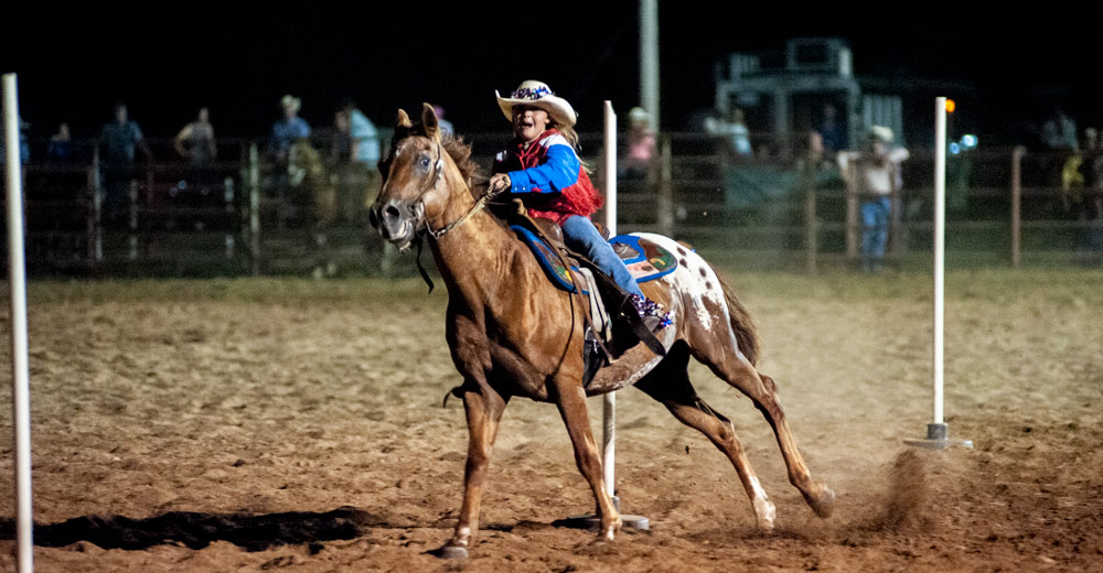 Girl doing Pole Bending at Thomasville Missouri Rodeo