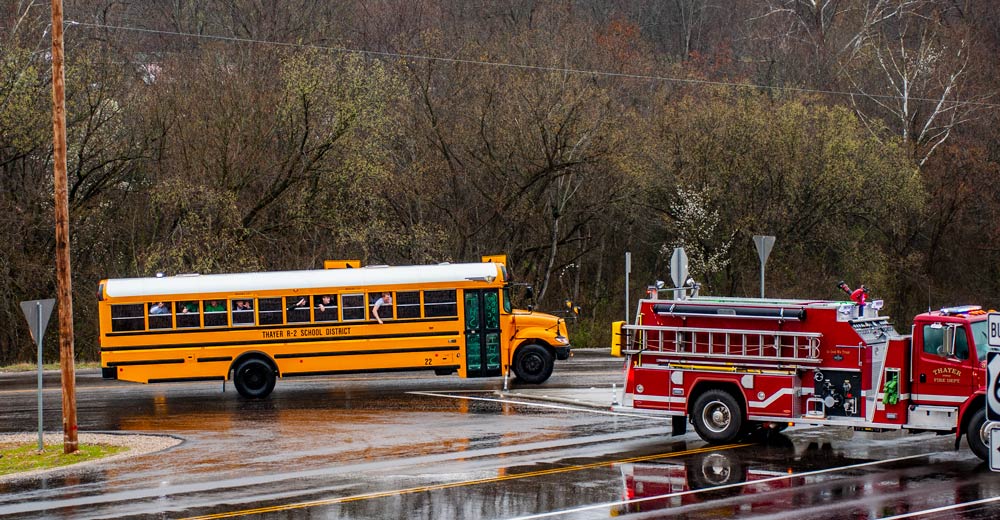 The 2023 Thayer Bobcats basketball team waving to fans on their way to the Final Four.