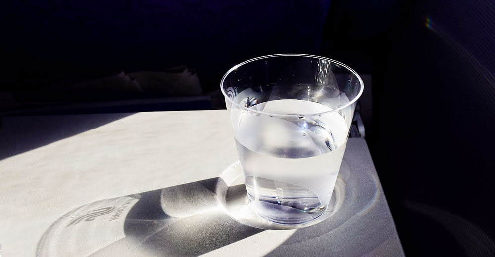 A cup of water on a table.