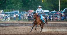 A cowgirl galloping to the final barrel at the Thomasville rodeo.