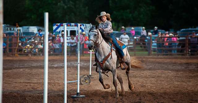 A cowgirl going through the poles at the Thomasville rodeo.