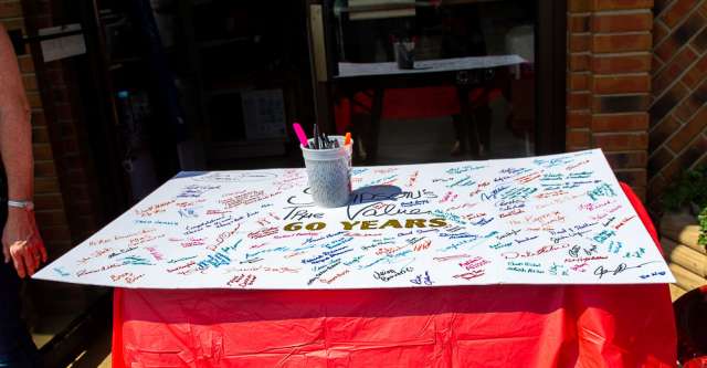 A poster board with signatures celebrating 60 years of Simpson's True Value.