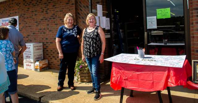 Holly Hart standing with a local at True Value's anniversary.