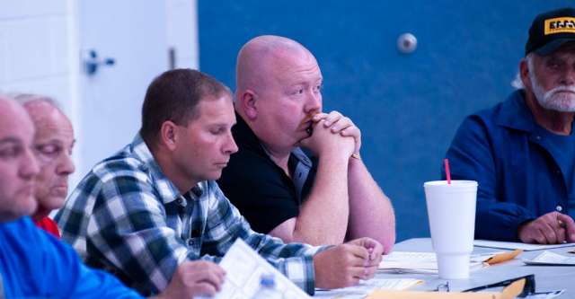 Members of the city council listen to everyone talking.