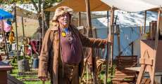 An old-timer standing next to his tent.