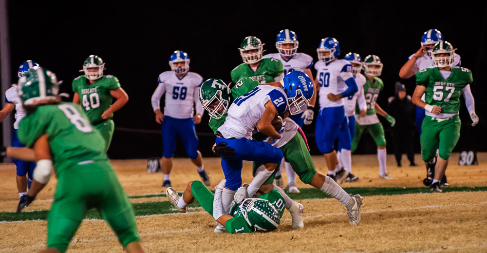 THAYER, MO – NOVEMBER 1: Clever Bluejays wide receiver Xavier Robinson (21) tires to push forward for more yards during the high school football game between the Thayer Bobcats and the Clever Bluejays on November 1, 2024, at the Thayer High School football field in Thayer, MO. (Photo by Curtis Thomas/AltonMo.com)