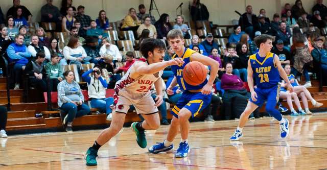 COUCH, MO – JANUARY 14: Couch Indian player (22) dribbles the ball past his opponent during the high school basketball game between the Alton Comets and Couch Indians on January 14, 2025 at the Couch High School Gym in Couch, Missouri. (Photo by Amanda Thomas/AltonMo.com)